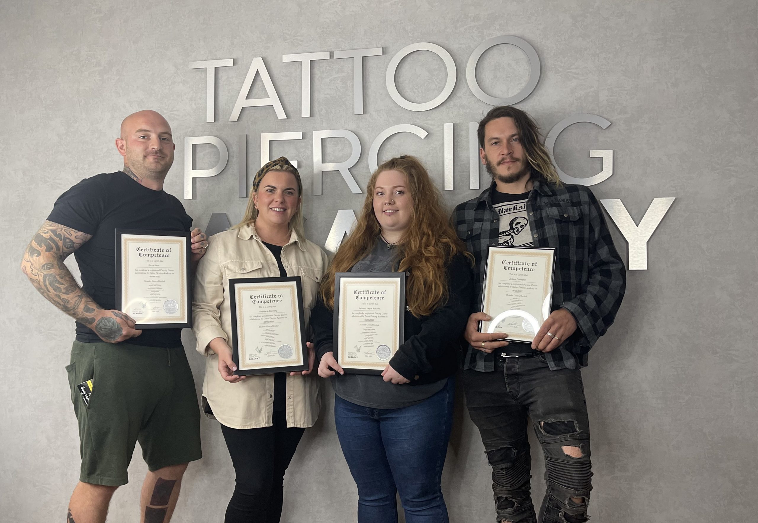 Body piercing students with their certificates after completing the course